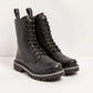 A pair of black leather lace-up boots with chunky lug soles, shown on a clean white studio background.